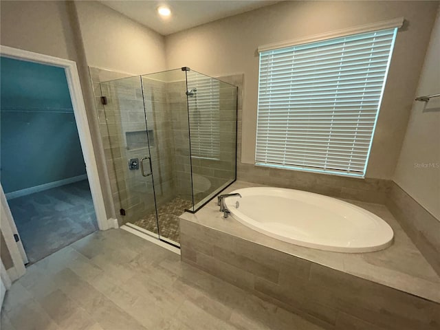 bathroom featuring separate shower and tub