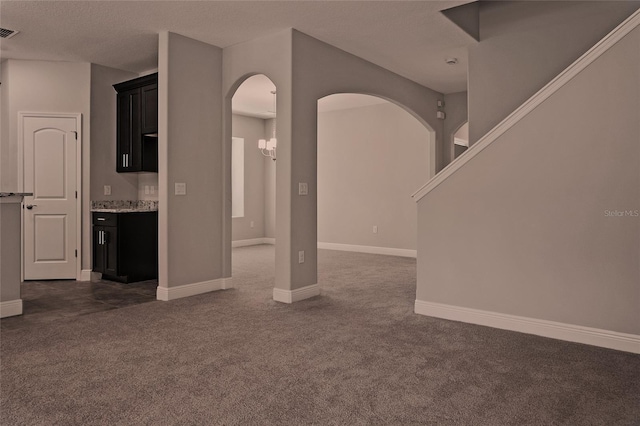 unfurnished living room with dark carpet