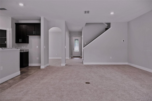 unfurnished living room featuring carpet flooring