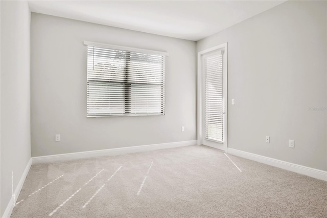 unfurnished room with light carpet