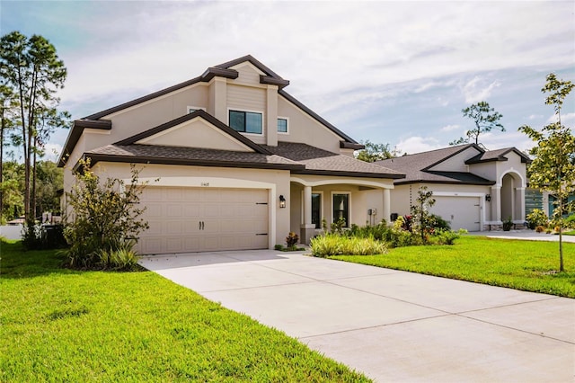 view of front of house with a garage, a front yard, and concrete driveway