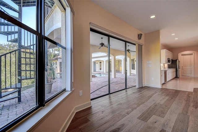 interior space featuring a wealth of natural light, ceiling fan, and light wood-type flooring