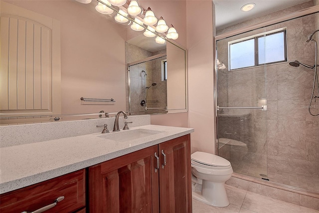 bathroom featuring vanity, tile patterned floors, toilet, and walk in shower