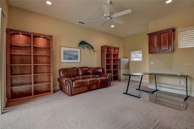 carpeted office featuring ceiling fan