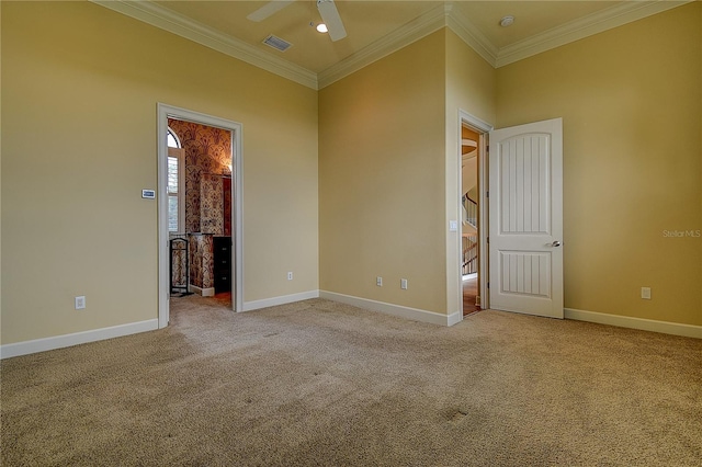 spare room featuring crown molding, light colored carpet, and ceiling fan