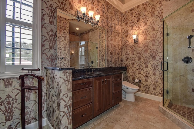 bathroom featuring vanity, a shower with shower door, ornamental molding, and toilet