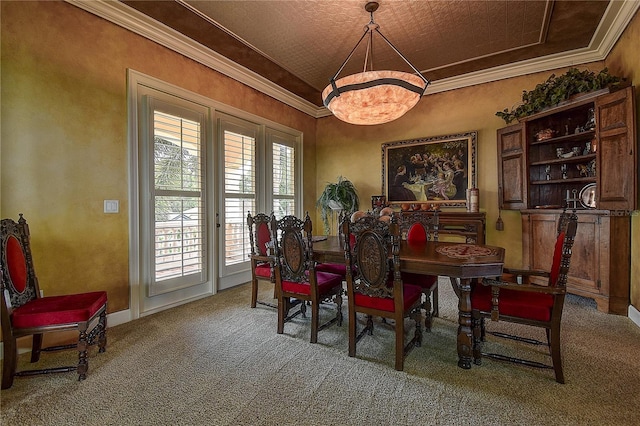 dining room with crown molding and carpet floors