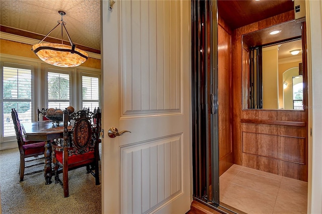 dining area featuring ornamental molding and elevator