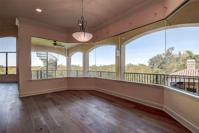 unfurnished sunroom featuring ceiling fan