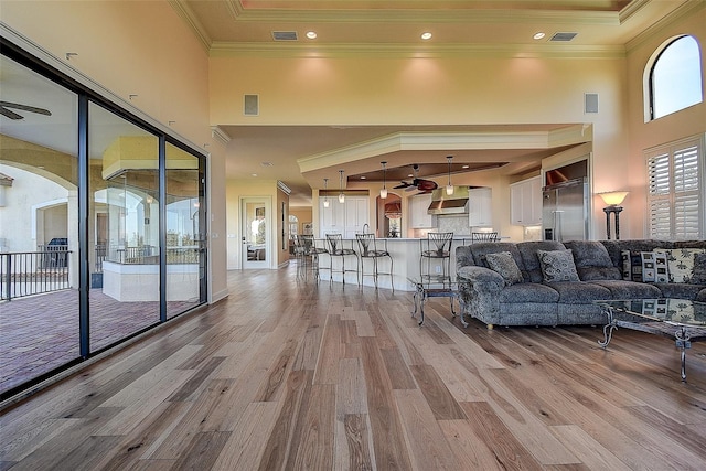 unfurnished living room with light hardwood / wood-style floors and a high ceiling