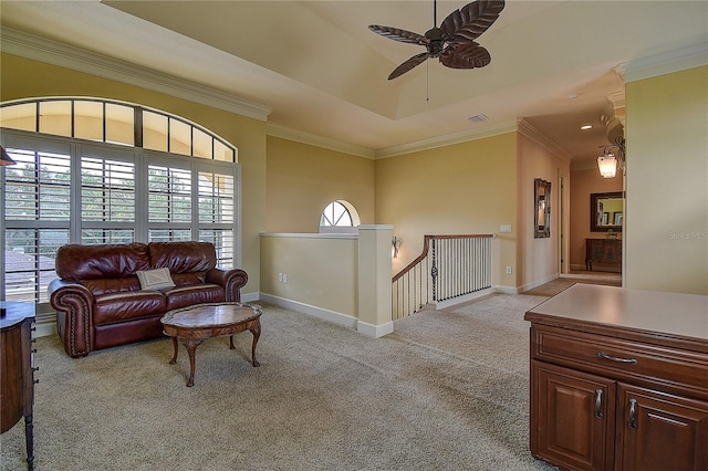 carpeted living room with ornamental molding and ceiling fan