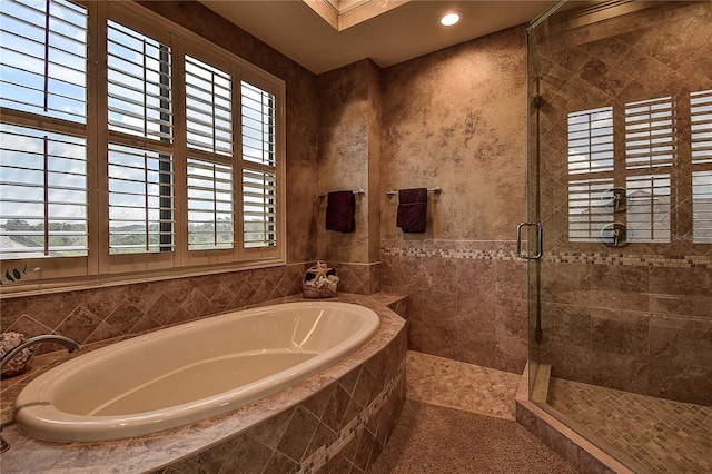 bathroom with separate shower and tub and a healthy amount of sunlight