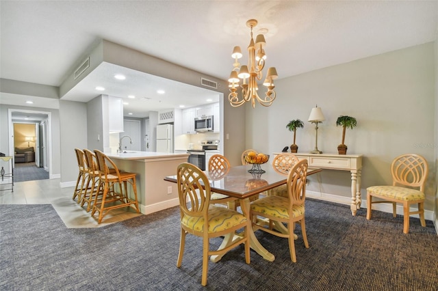 tiled dining area featuring a notable chandelier