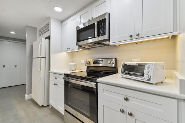 kitchen with white cabinets and appliances with stainless steel finishes