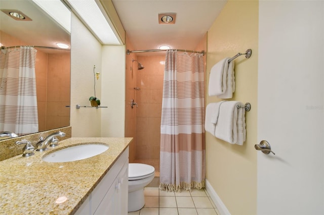 bathroom with tile flooring, large vanity, and toilet