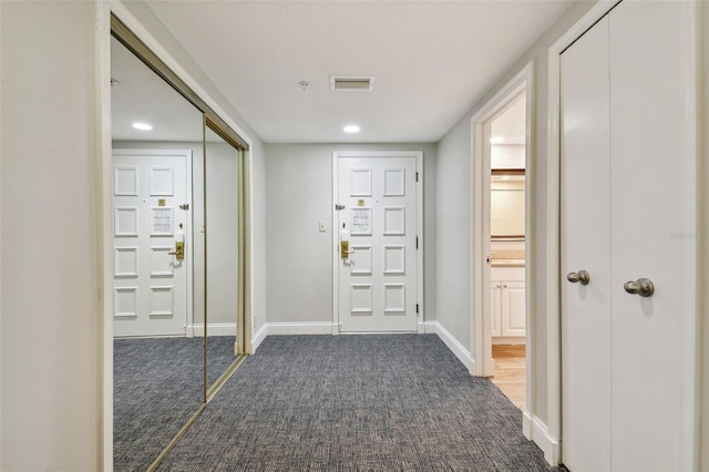 foyer with dark colored carpet