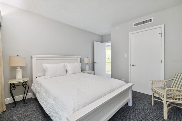 bedroom featuring dark carpet