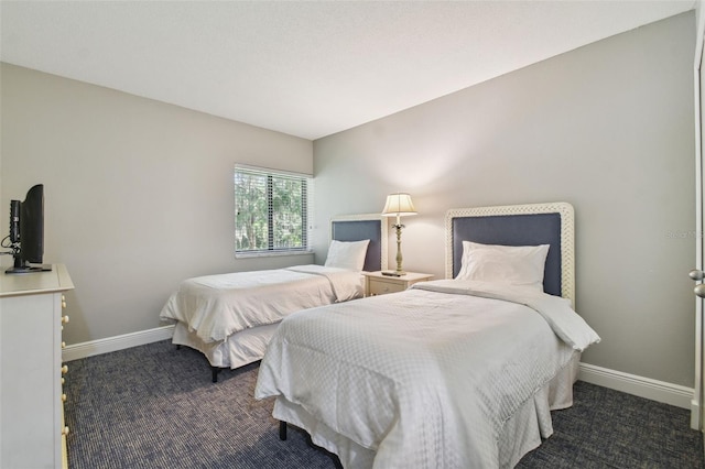 bedroom with dark colored carpet