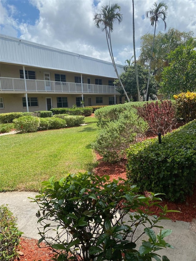 view of home's community with a lawn