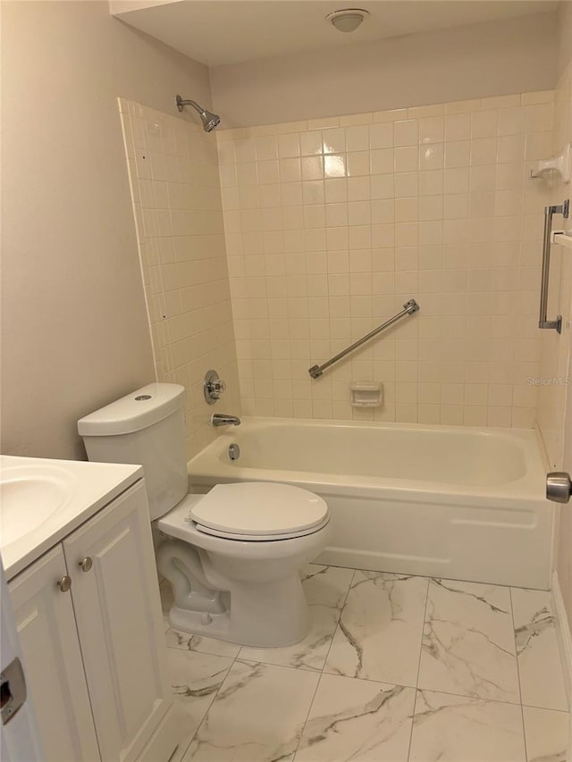 bathroom with toilet, marble finish floor, bathing tub / shower combination, and vanity