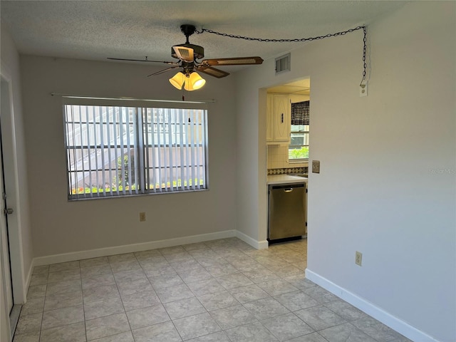 interior space featuring a textured ceiling, ceiling fan, dishwasher, light tile patterned floors, and tasteful backsplash