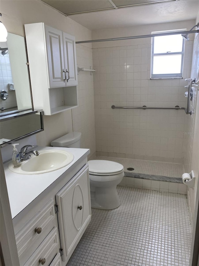 bathroom featuring toilet, vanity, and tile patterned flooring