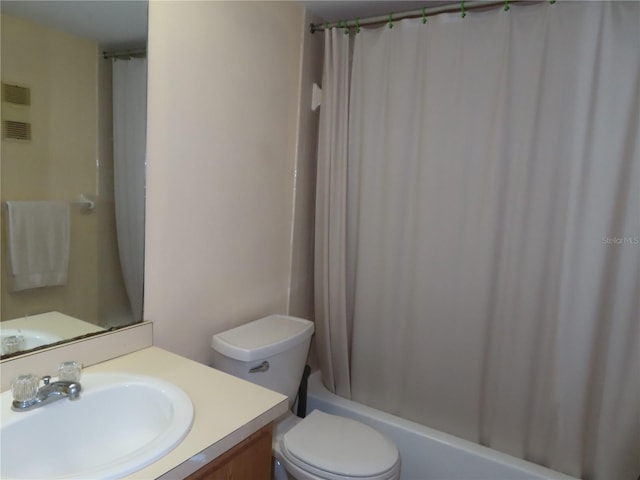 full bathroom with toilet, shower / tub combo, and vanity