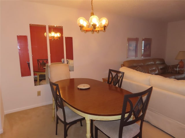 dining room featuring a chandelier and light colored carpet