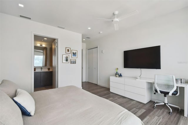 bedroom with connected bathroom, a closet, ceiling fan, and dark hardwood / wood-style floors