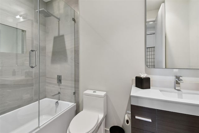 full bathroom with vanity, enclosed tub / shower combo, and toilet