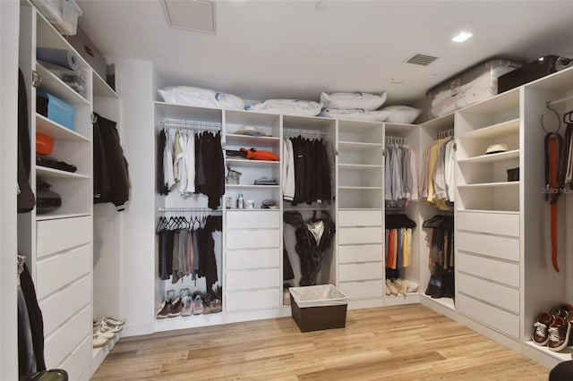 spacious closet with light hardwood / wood-style floors