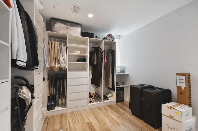 spacious closet with light hardwood / wood-style flooring