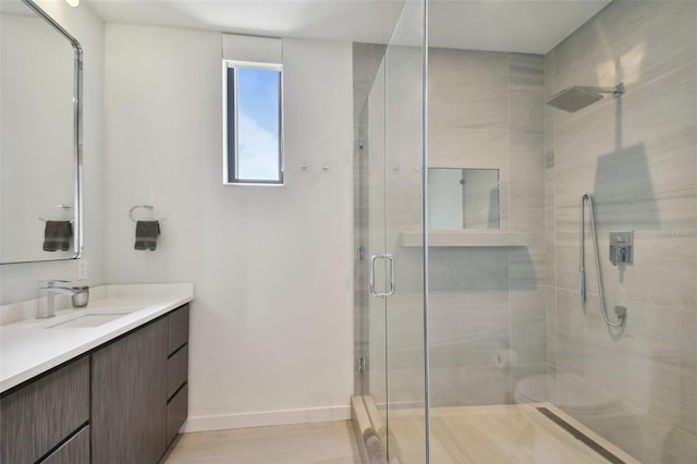 bathroom featuring an enclosed shower and vanity