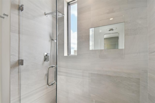 bathroom with an enclosed shower and a healthy amount of sunlight