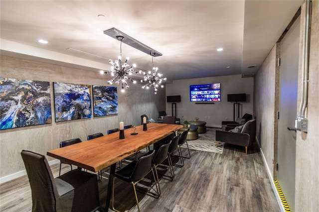 dining room featuring a notable chandelier and hardwood / wood-style flooring