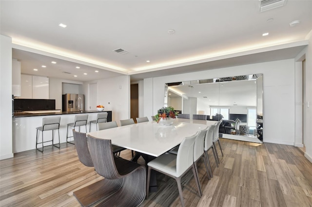 dining space featuring light wood-type flooring