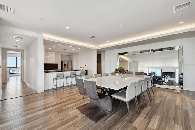 dining space with light hardwood / wood-style flooring