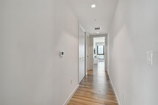 corridor with light hardwood / wood-style flooring