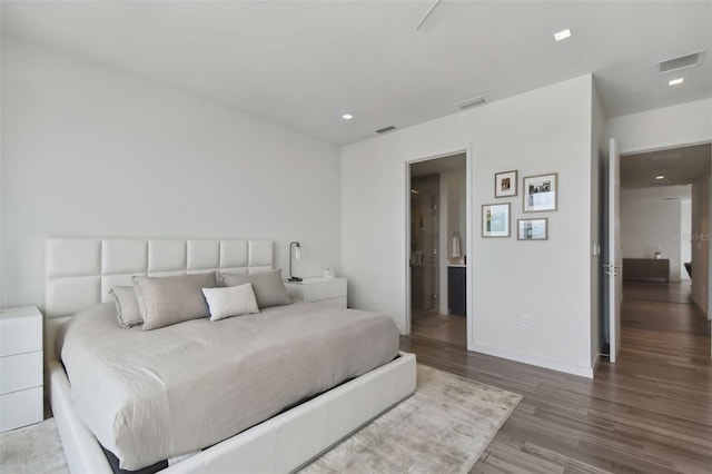 bedroom with hardwood / wood-style flooring