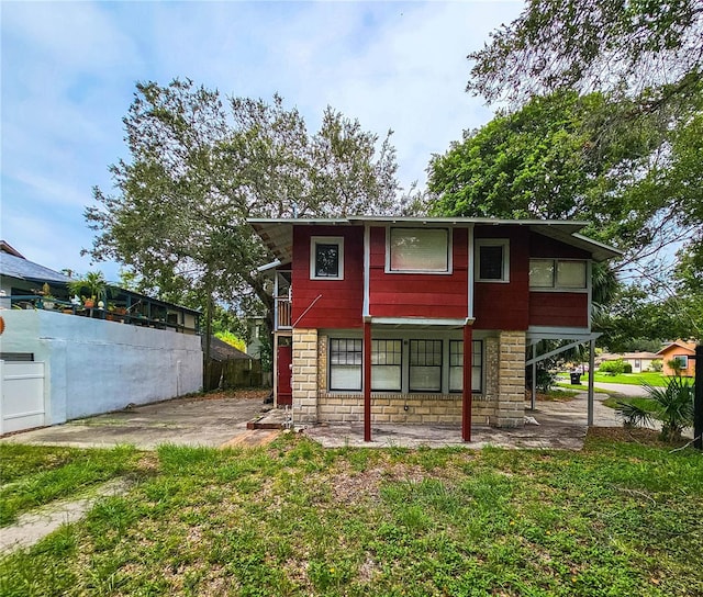 rear view of house with a yard and a patio area