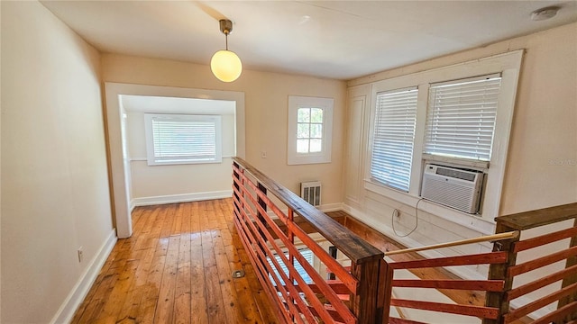 hallway with cooling unit and light wood-type flooring