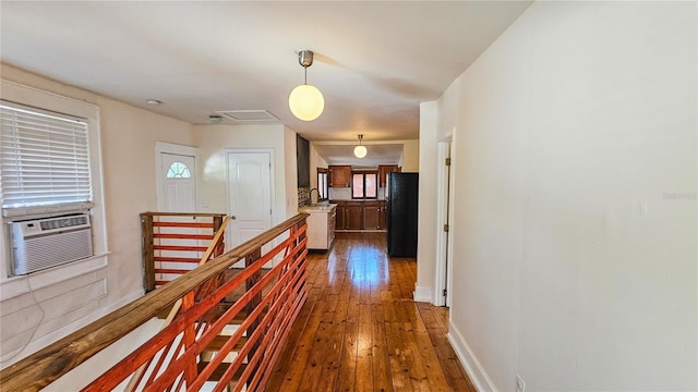 corridor featuring sink, dark hardwood / wood-style floors, and cooling unit