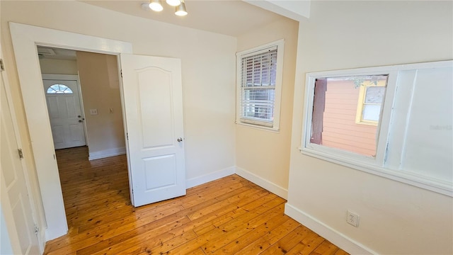 unfurnished room with light hardwood / wood-style flooring