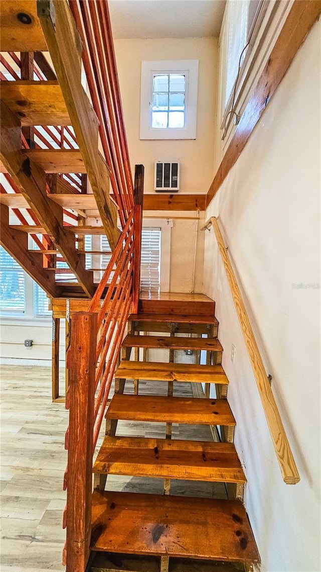 stairs featuring hardwood / wood-style flooring