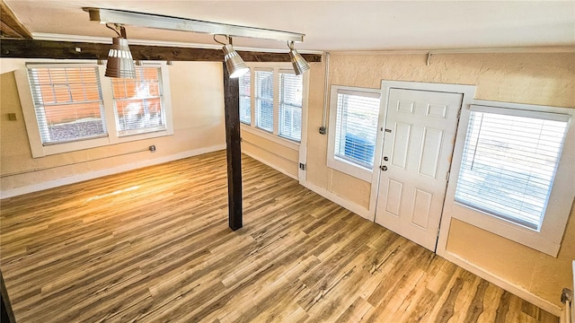 foyer entrance with wood-type flooring and ornamental molding