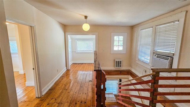 interior space with cooling unit and hardwood / wood-style floors