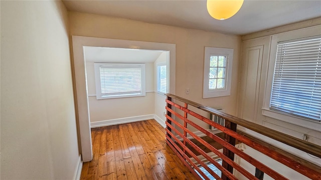 corridor with wood-type flooring