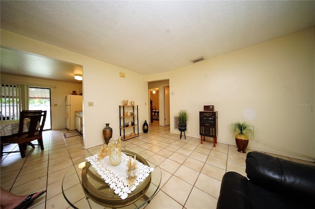 living room featuring light tile floors and a textured ceiling