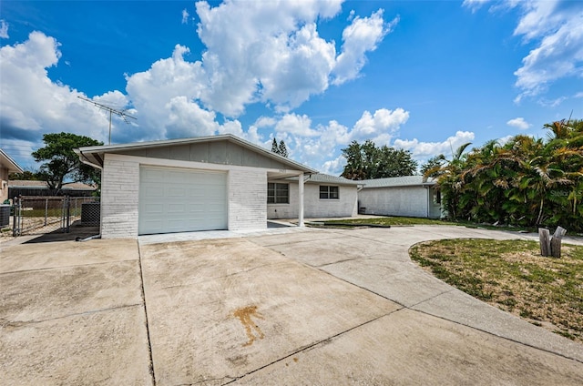 ranch-style house with central AC and a garage