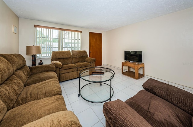 living room featuring light tile floors and a textured ceiling